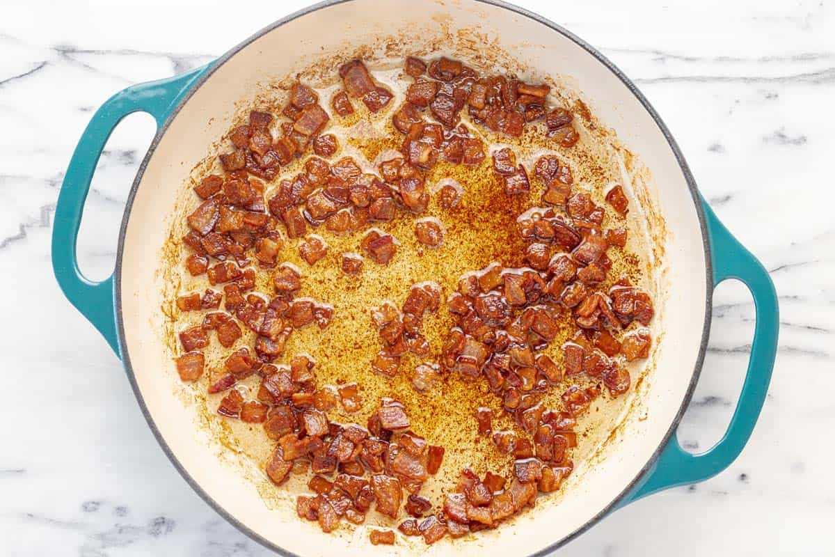 Crispy bacon in drippings in a large pan.