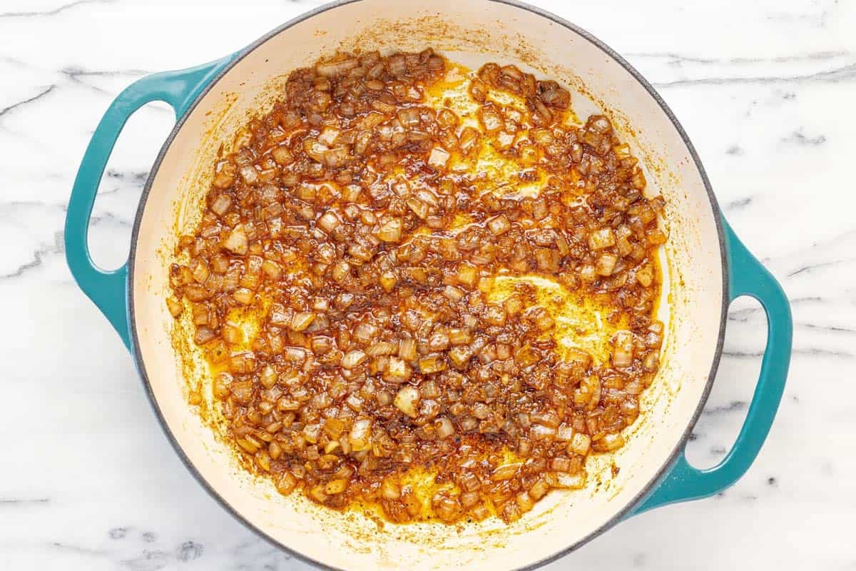 Sauteed onions and spices in a large pan.