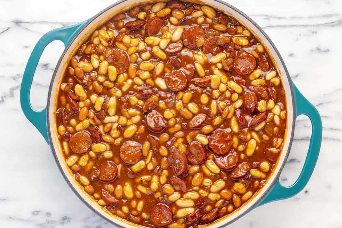 Homemade baked beans in a large pan ready to go in the oven.