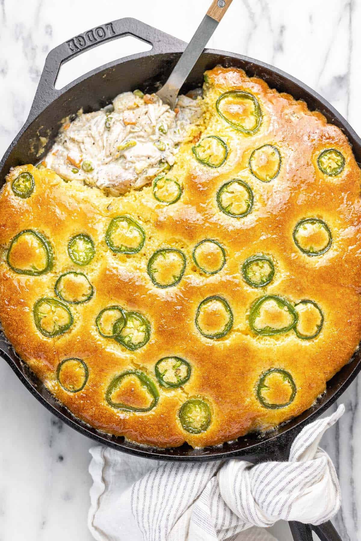 Large skillet filled with homemade cornbread chicken pot pie.