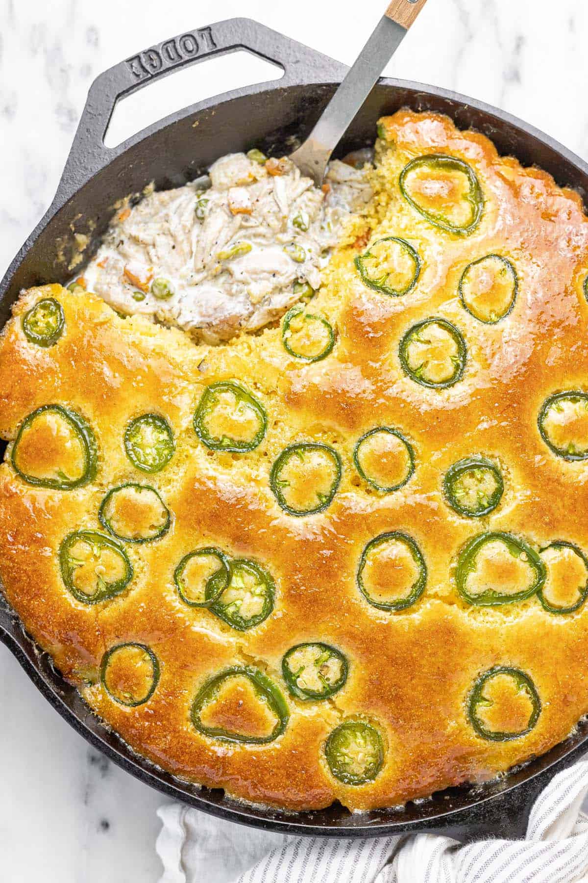 Large skillet filled with homemade cornbread chicken pot pie.