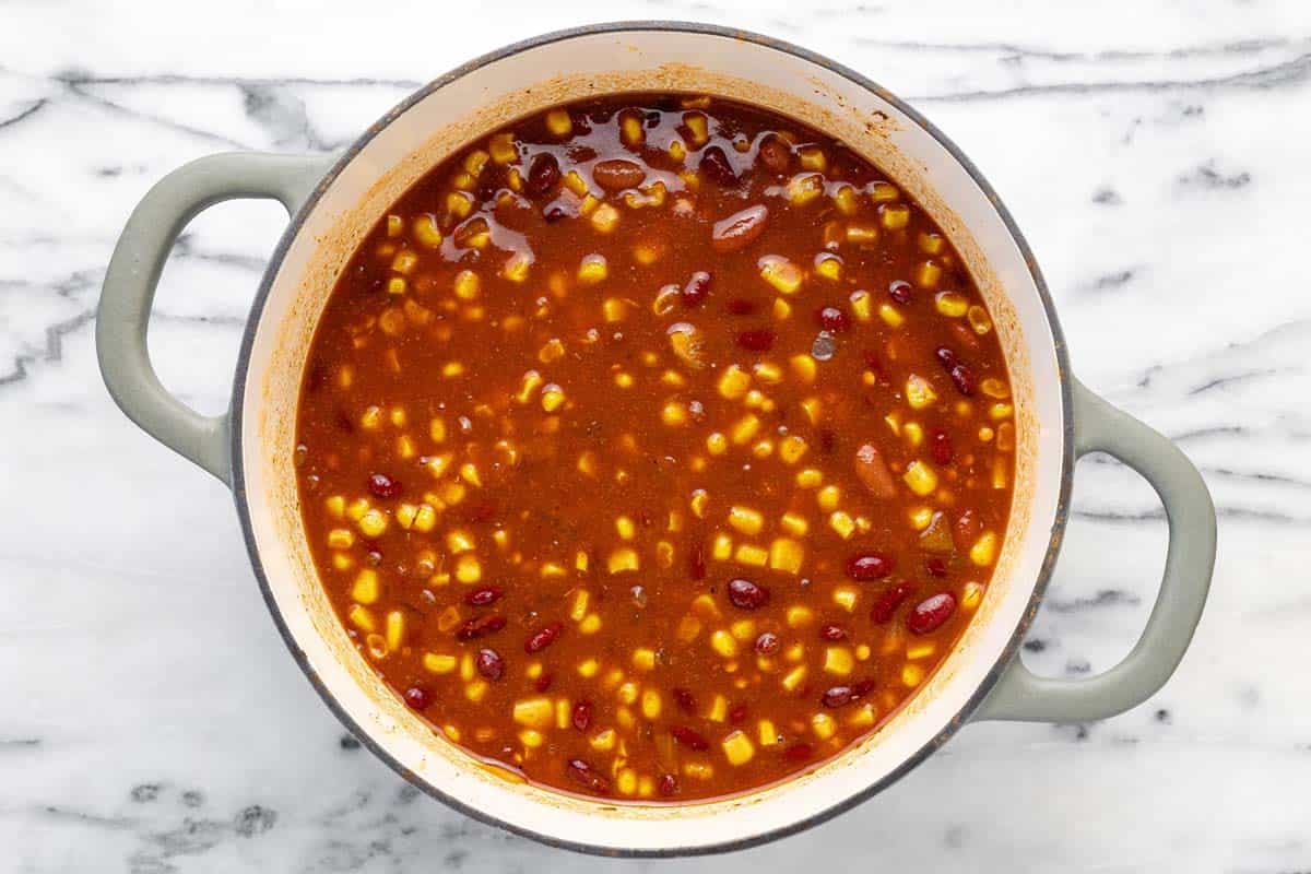 Ingredients to make vegetarian chili in a large pot.